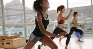 a group of women exercising in a group class to boost your energy